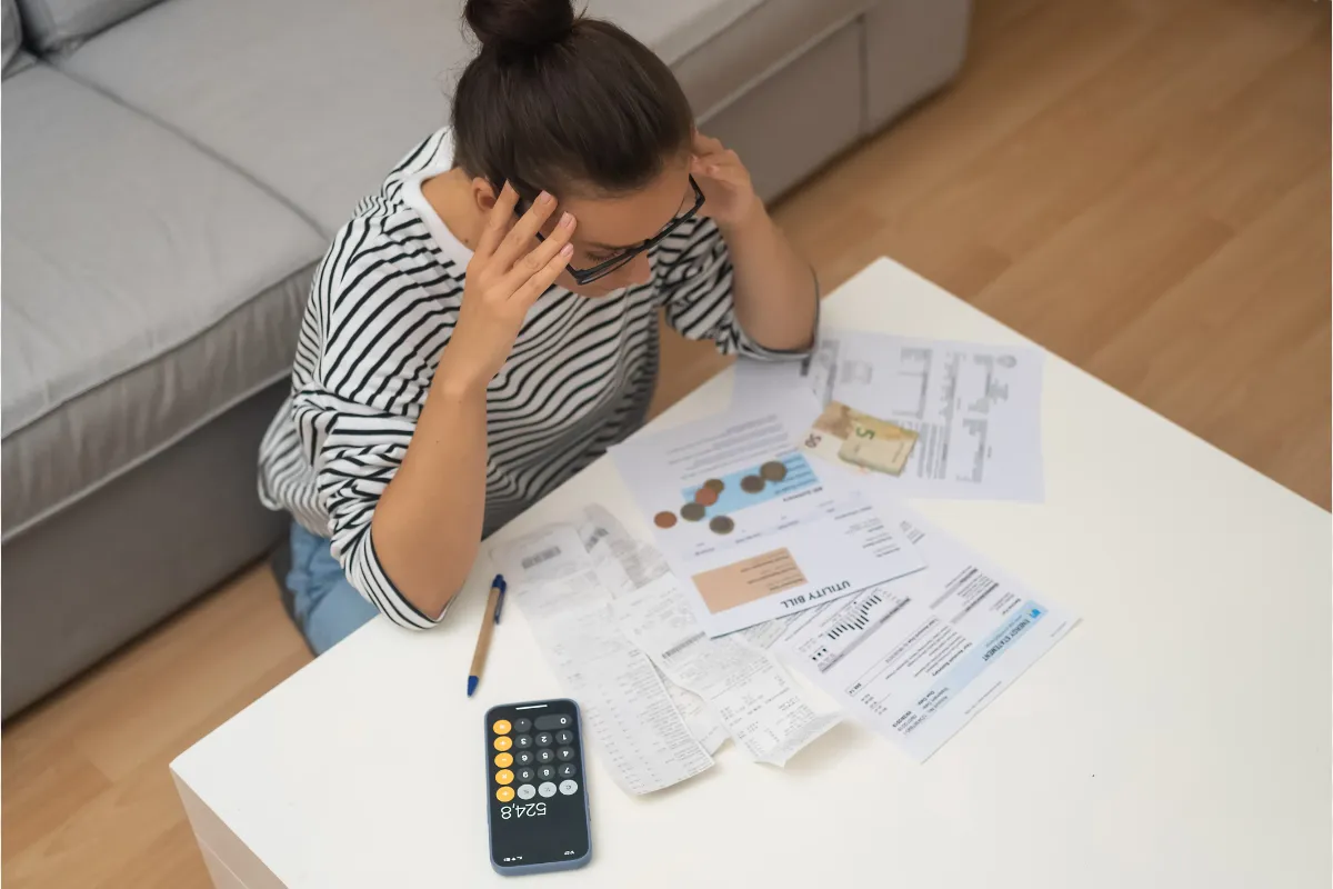 Woman stressed over finances holding credit cards