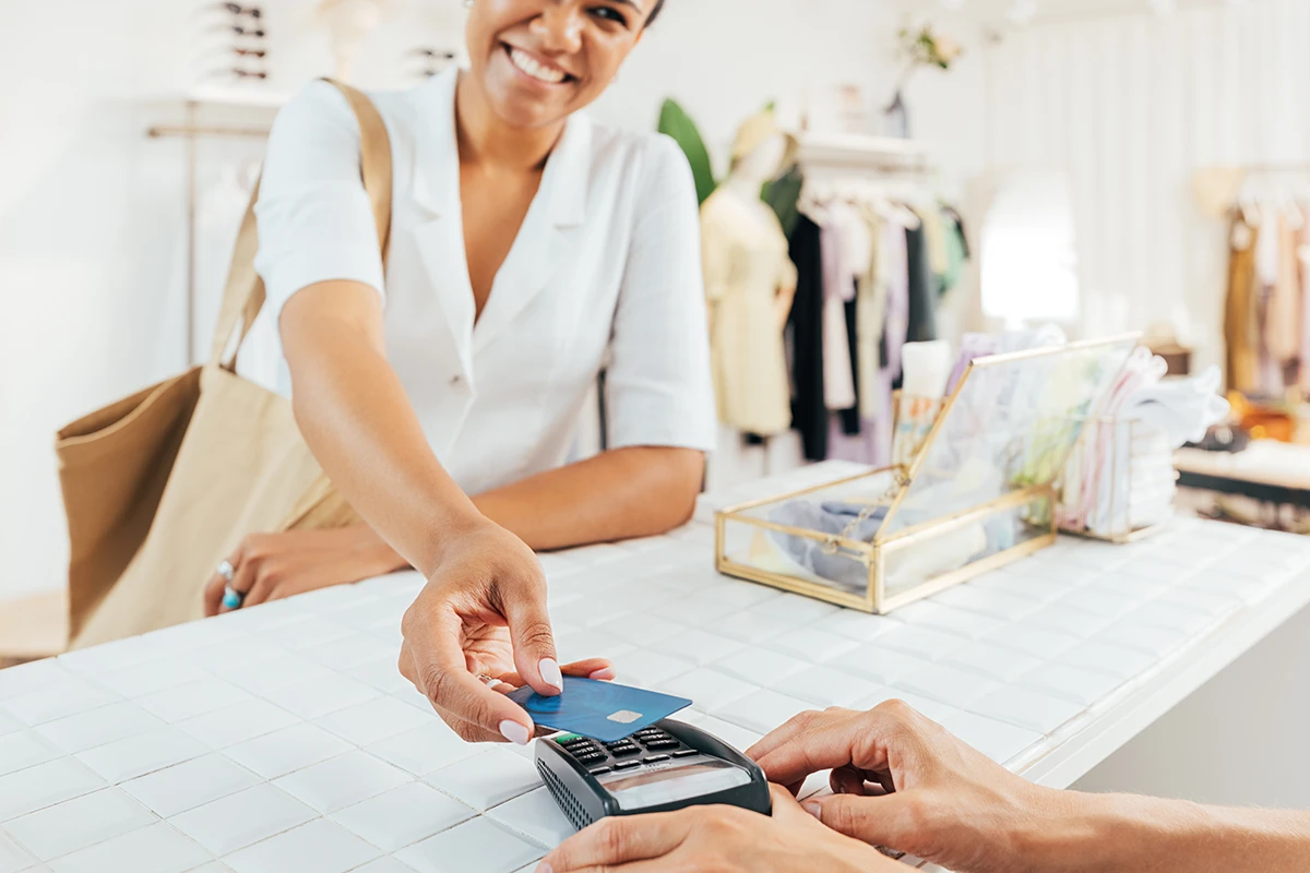 Customer paying boutique cashier with credit card