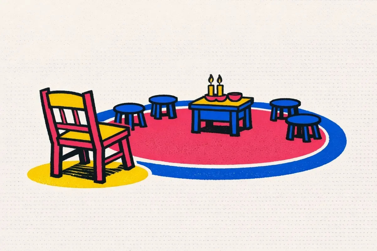 A wooden chair stands outside the coloured circle around a small altar table.