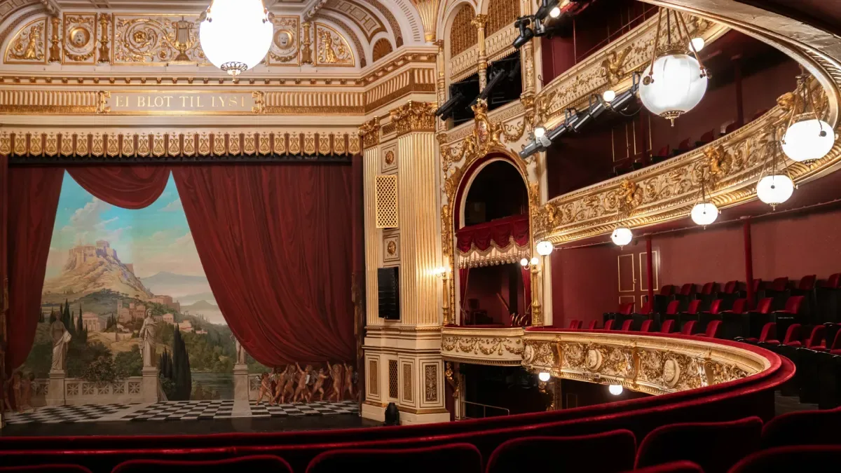 Den historiske sal på Gamle Scene med balkoner, guldornamenter og røde plyssæder.