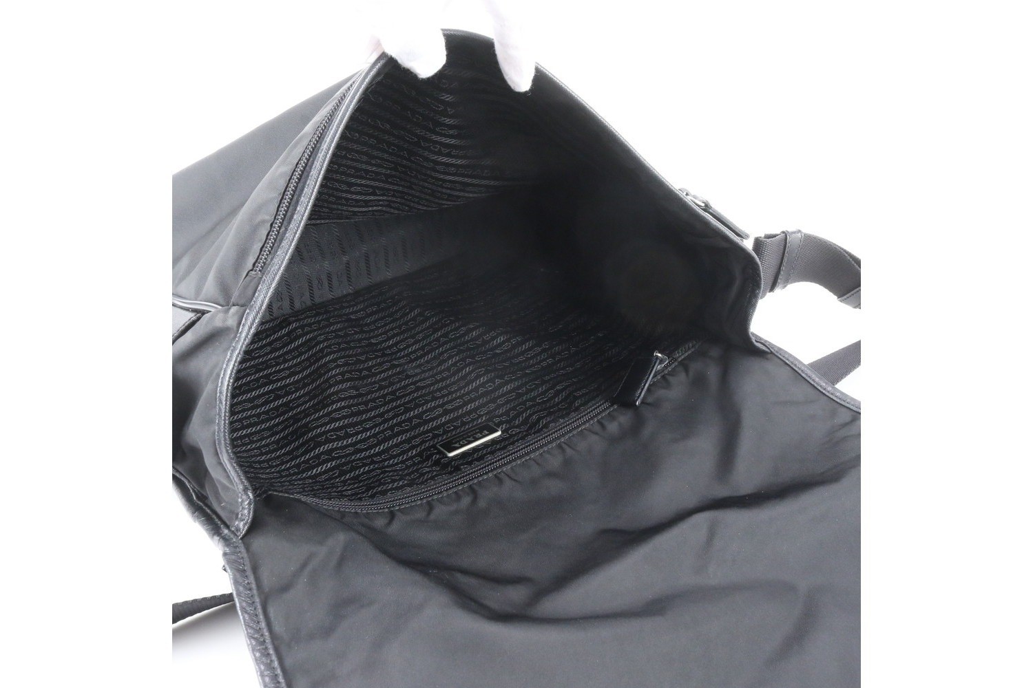 Tessuto nylon shoulder bag with white tag, triangle logo, and leather accents. — view 7