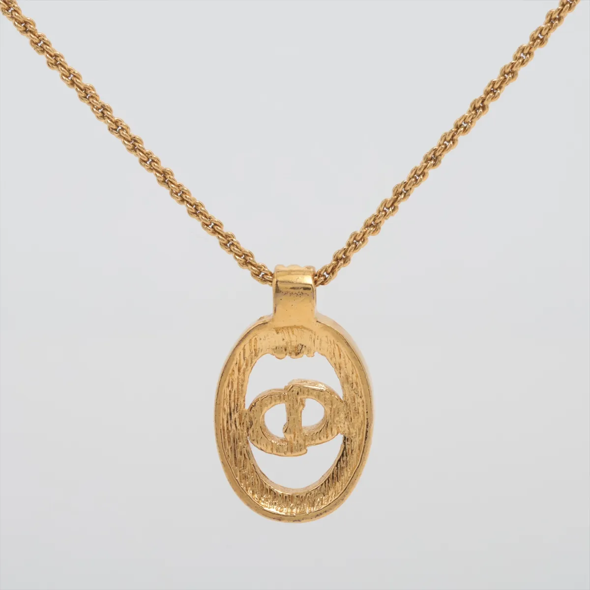 CD logo necklace, gold plated with rhinestones. Shows signs of wear, tarnishing, — view 2