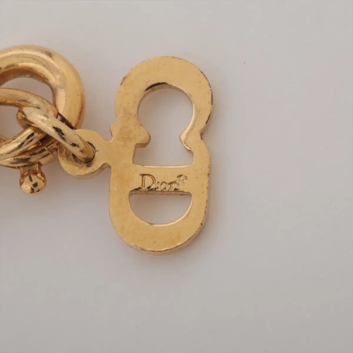 CD logo necklace, gold plated with rhinestones. Shows signs of wear, tarnishing, — view 4