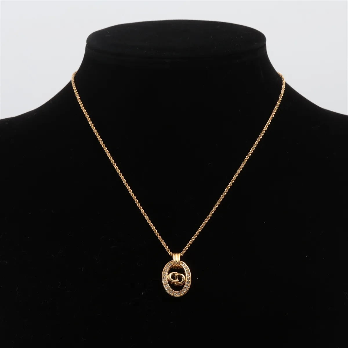 CD logo necklace, gold plated with rhinestones. Shows signs of wear, tarnishing, — view 5