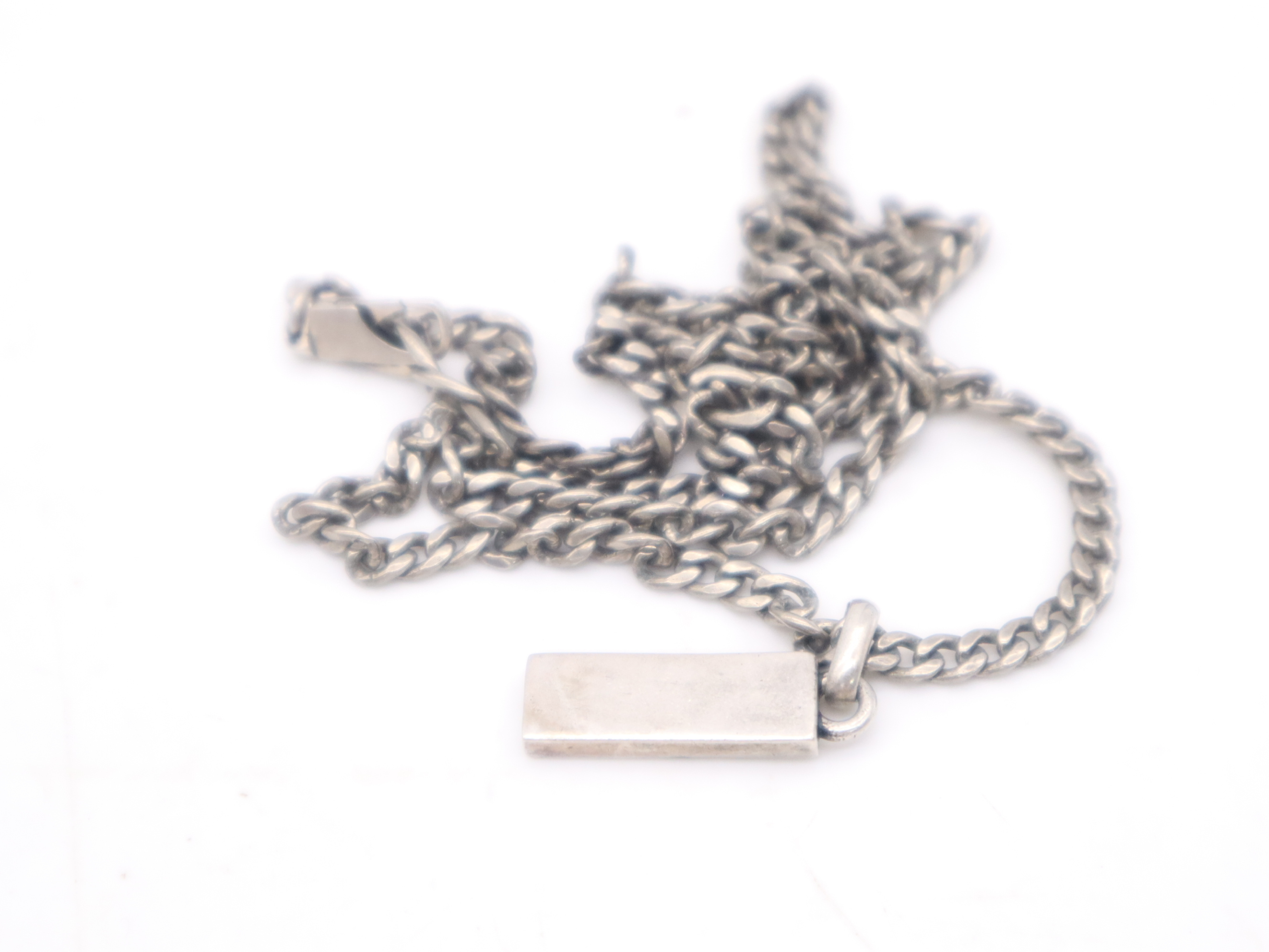 necklace with silver logo plate, box, and dust bag. — view 2