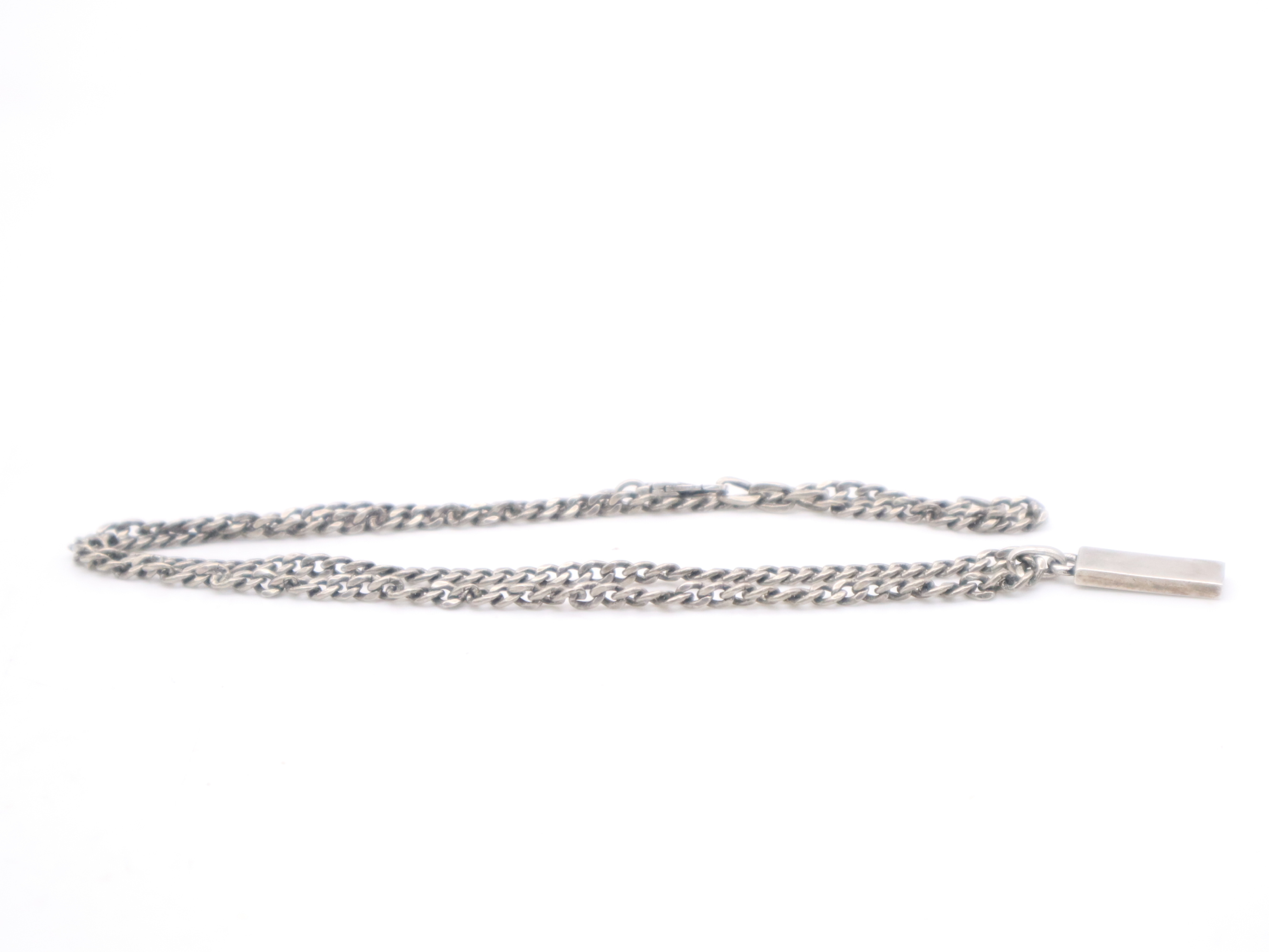 necklace with silver logo plate, box, and dust bag. — view 3