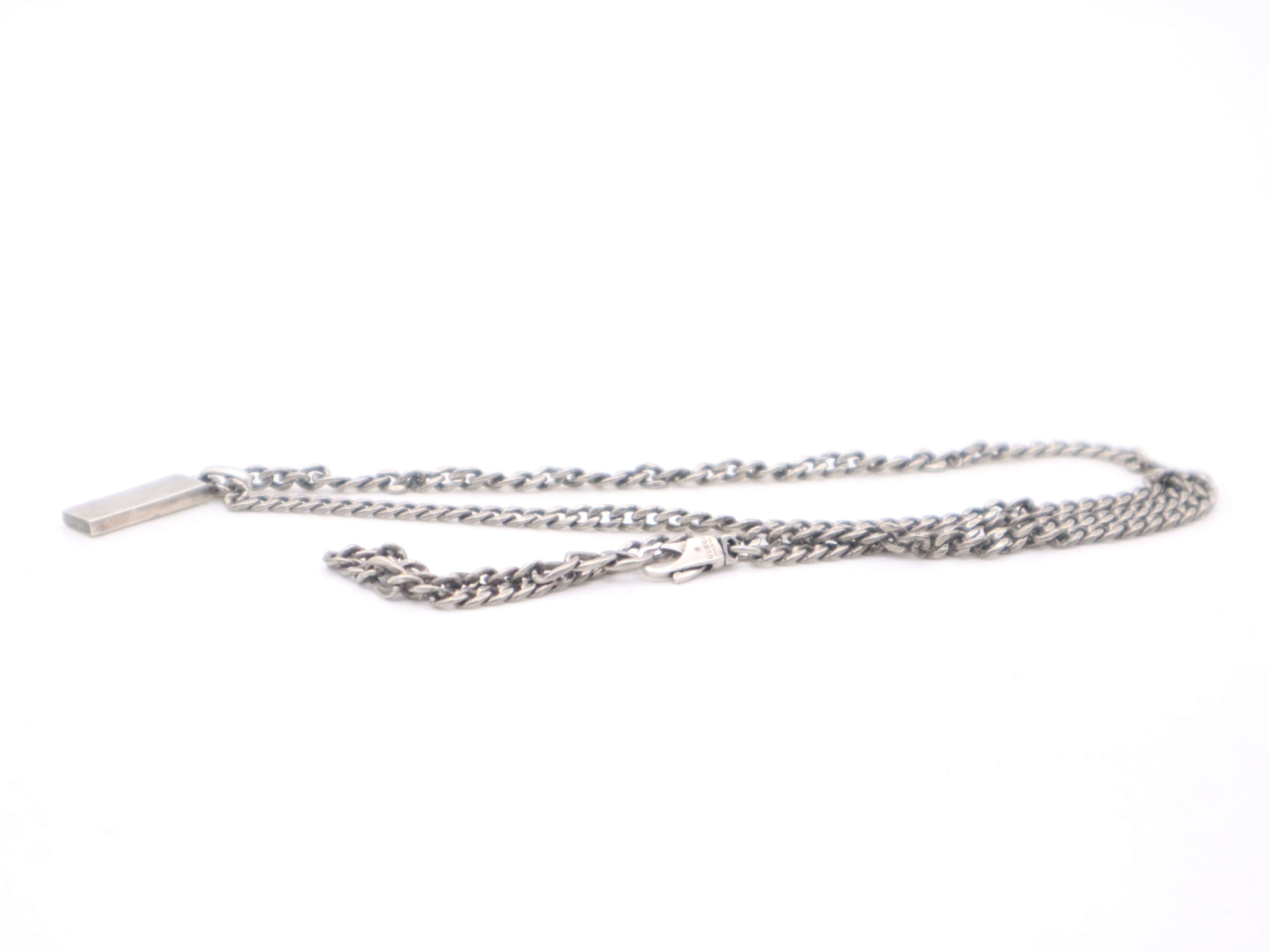 necklace with silver logo plate, box, and dust bag. — view 5