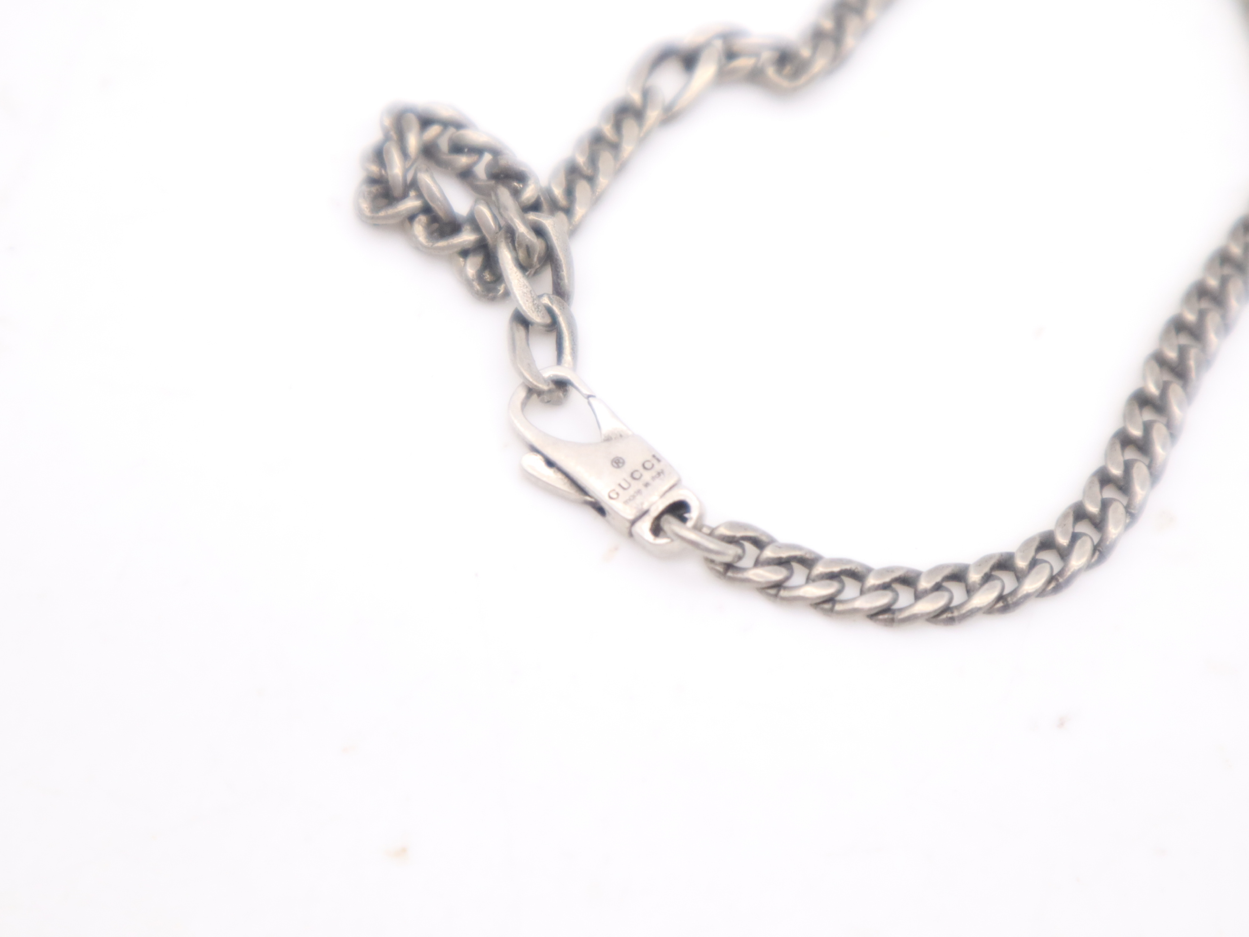 necklace with silver logo plate, box, and dust bag. — view 6