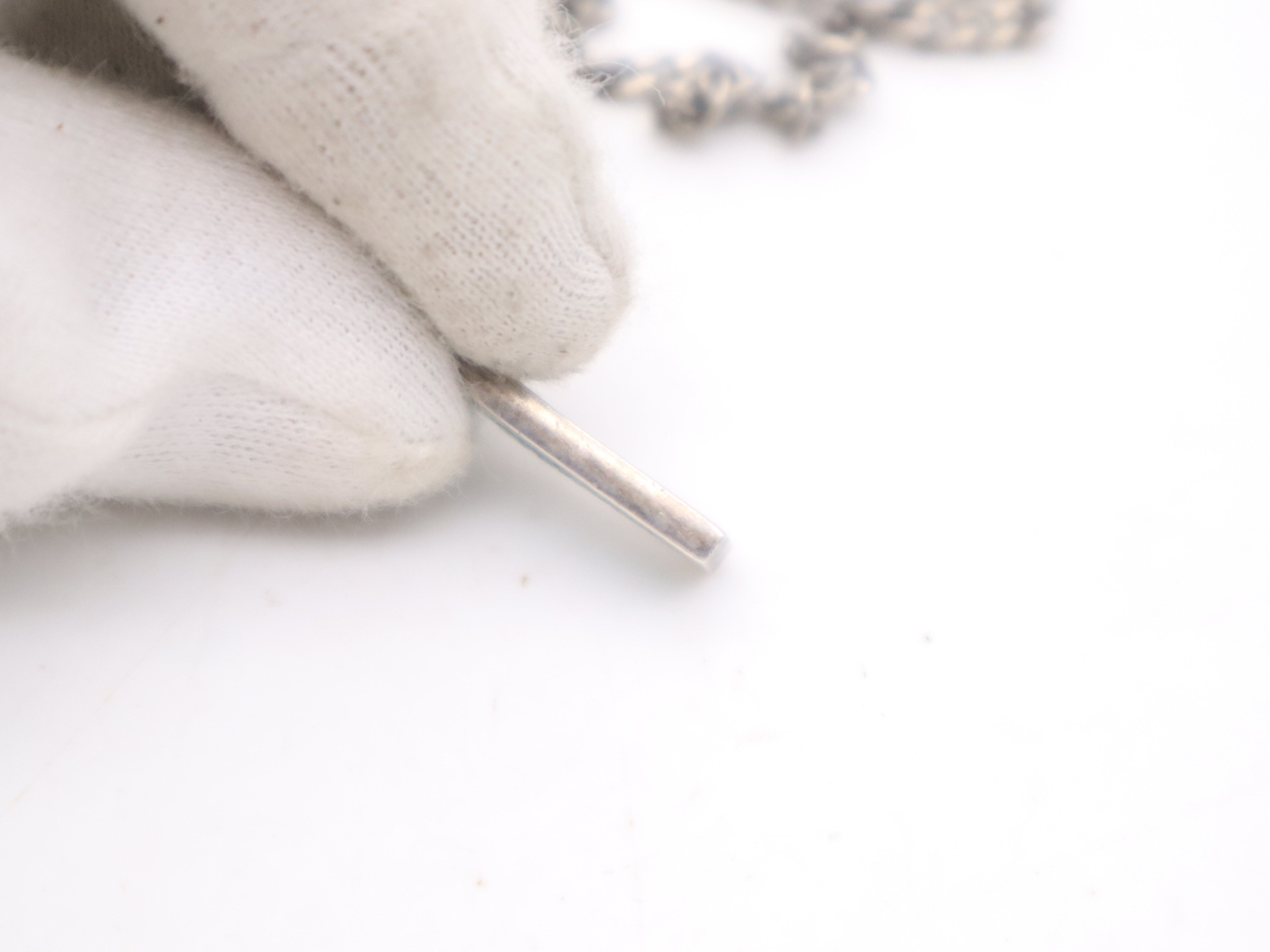 necklace with silver logo plate, box, and dust bag. — view 7