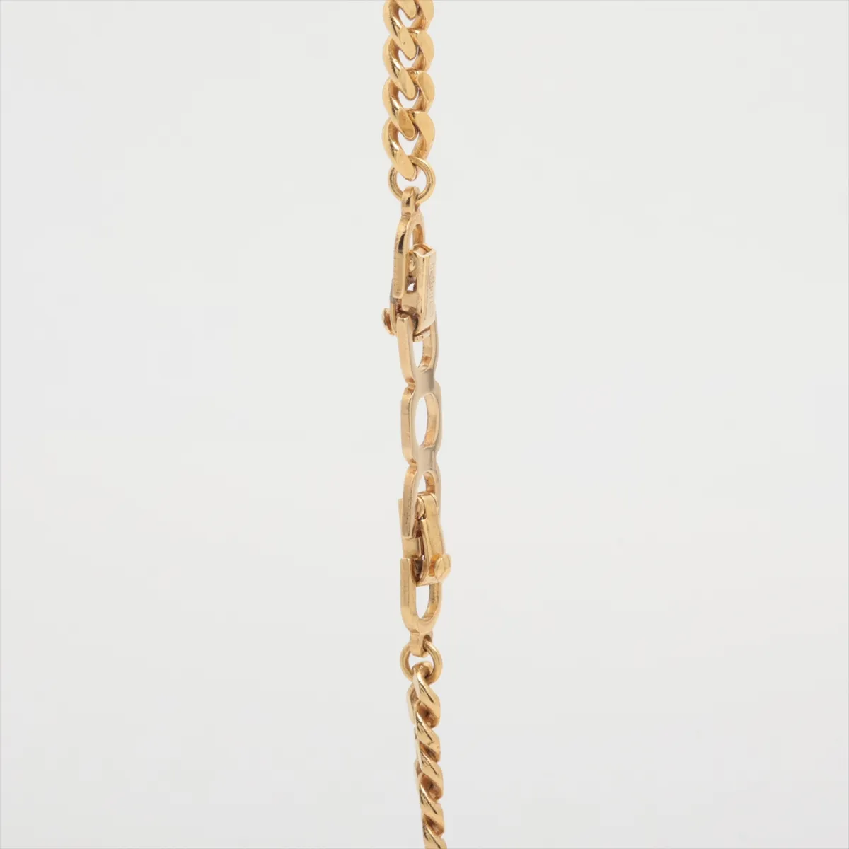 CD logo necklace, gold plated with rhinestones. Shows signs of wear, including — view 3