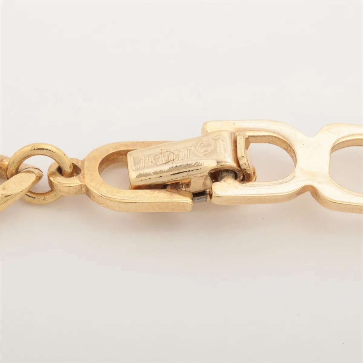 CD logo necklace, gold plated with rhinestones. Shows signs of wear, including — view 4