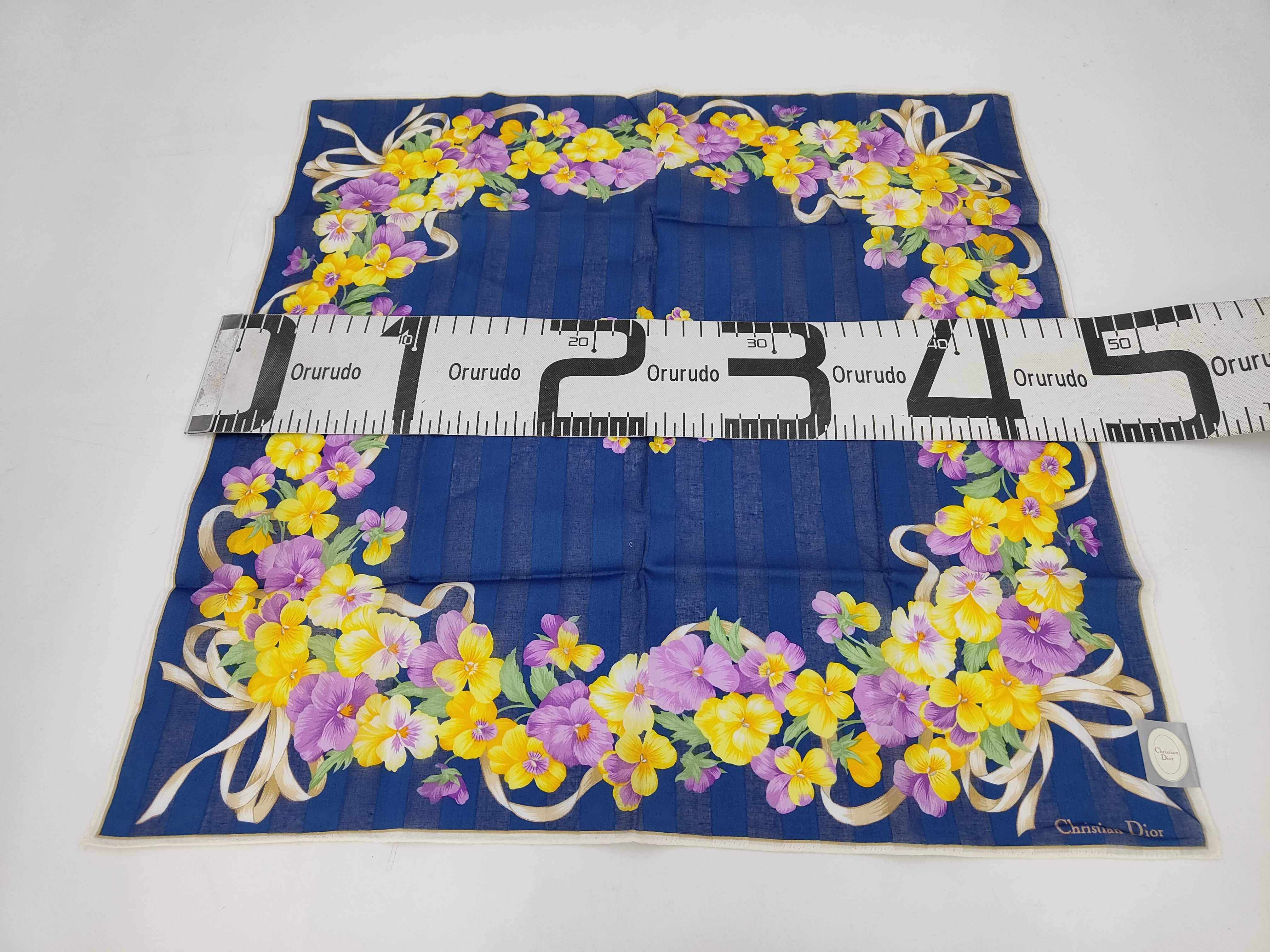 handkerchief scarf with sticker, logo, floral pattern, ribbon, navy, and other accessories. — view 2