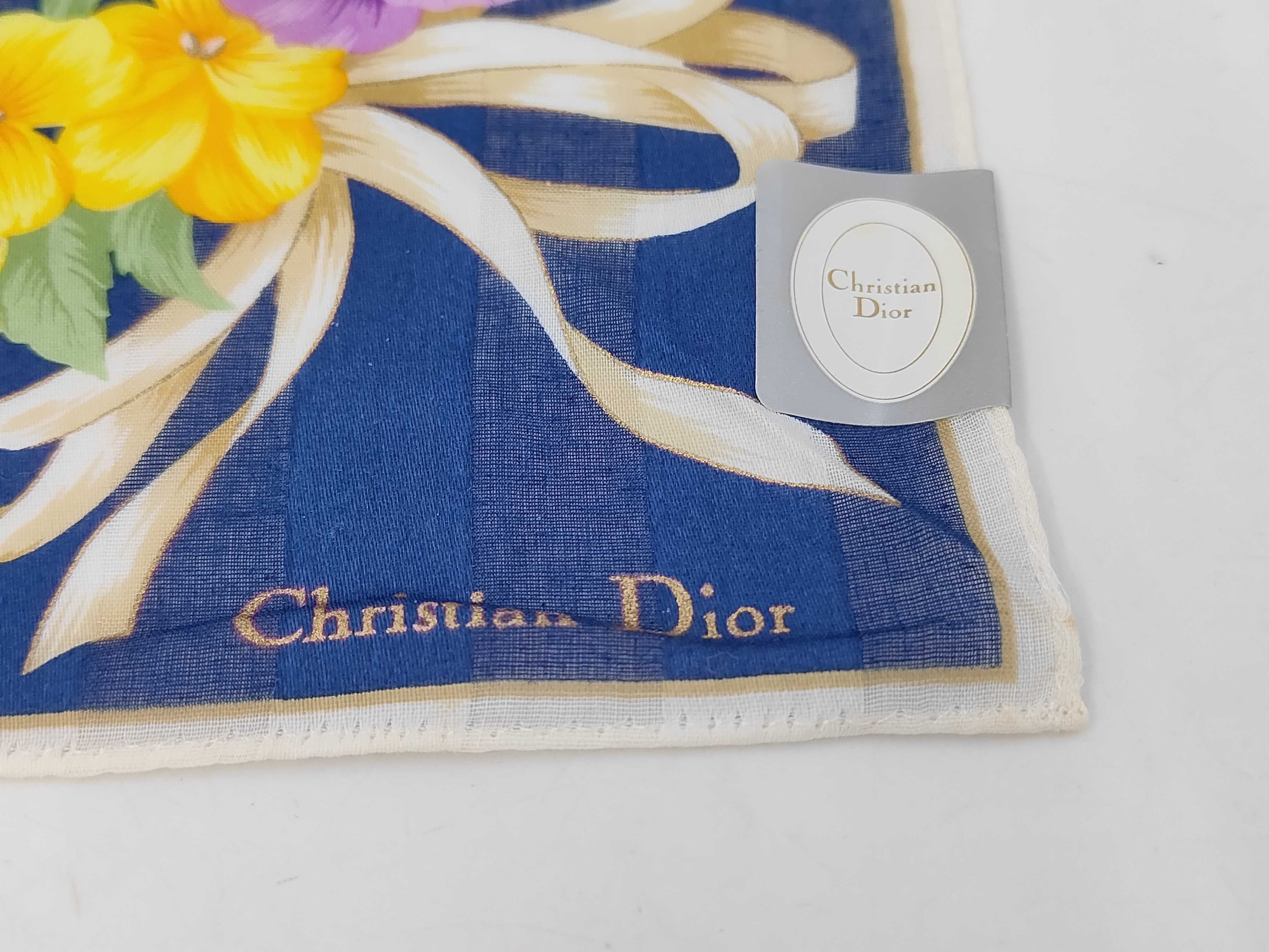 handkerchief scarf with sticker, logo, floral pattern, ribbon, navy, and other accessories. — view 3