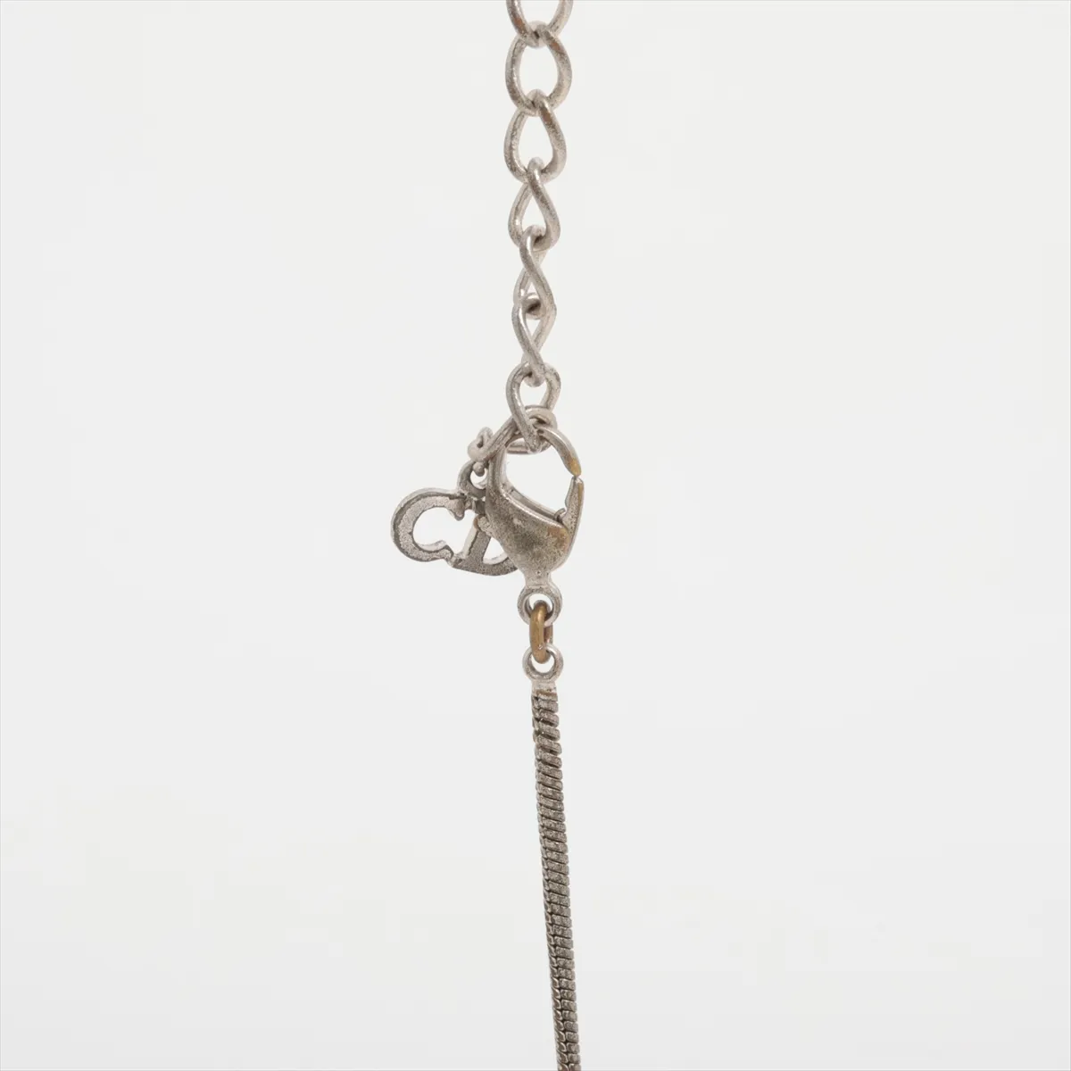 CD logo necklace, metal, silver. Shows signs of wear including dents, — view 3