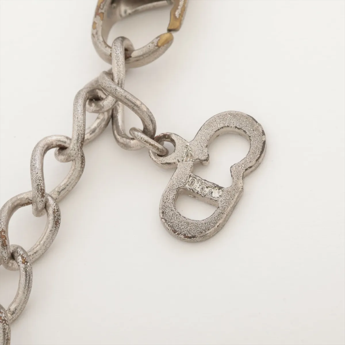 CD logo necklace, metal, silver. Shows signs of wear including dents, — view 4