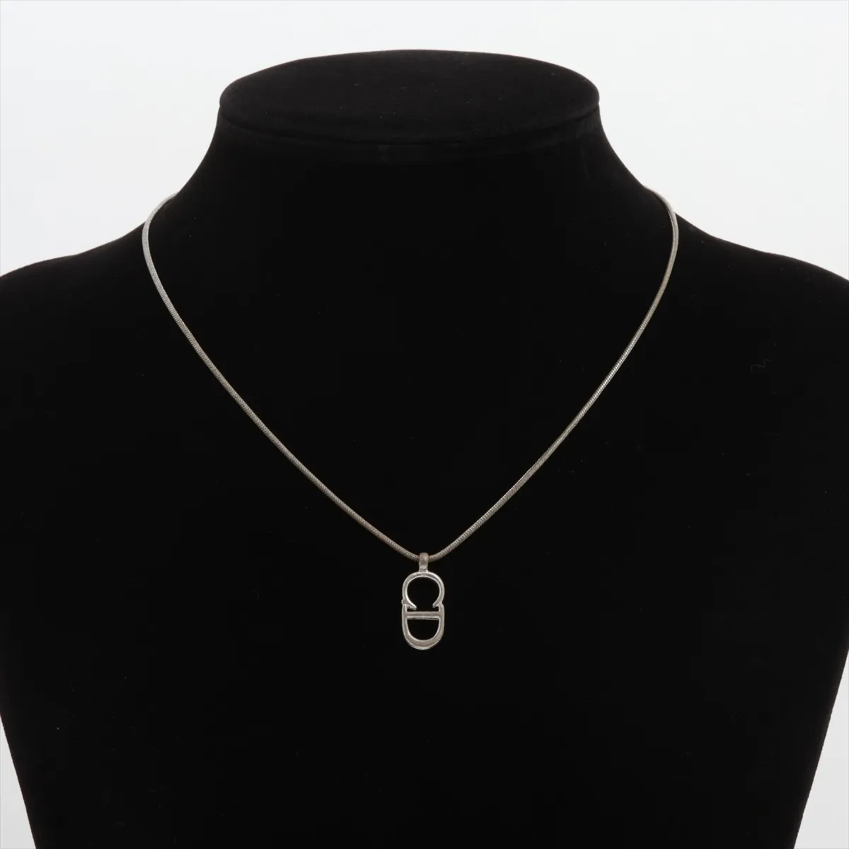 CD logo necklace, metal, silver. Shows signs of wear including dents, — view 5