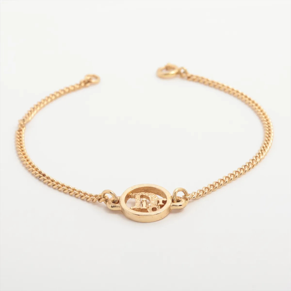 logo bracelet, gold plated with rhinestones. Shows signs of wear,