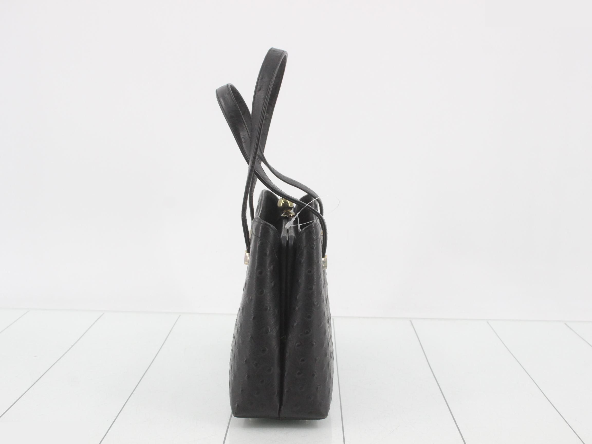 Black ostrich leather handbag with clasp closure. — view 3