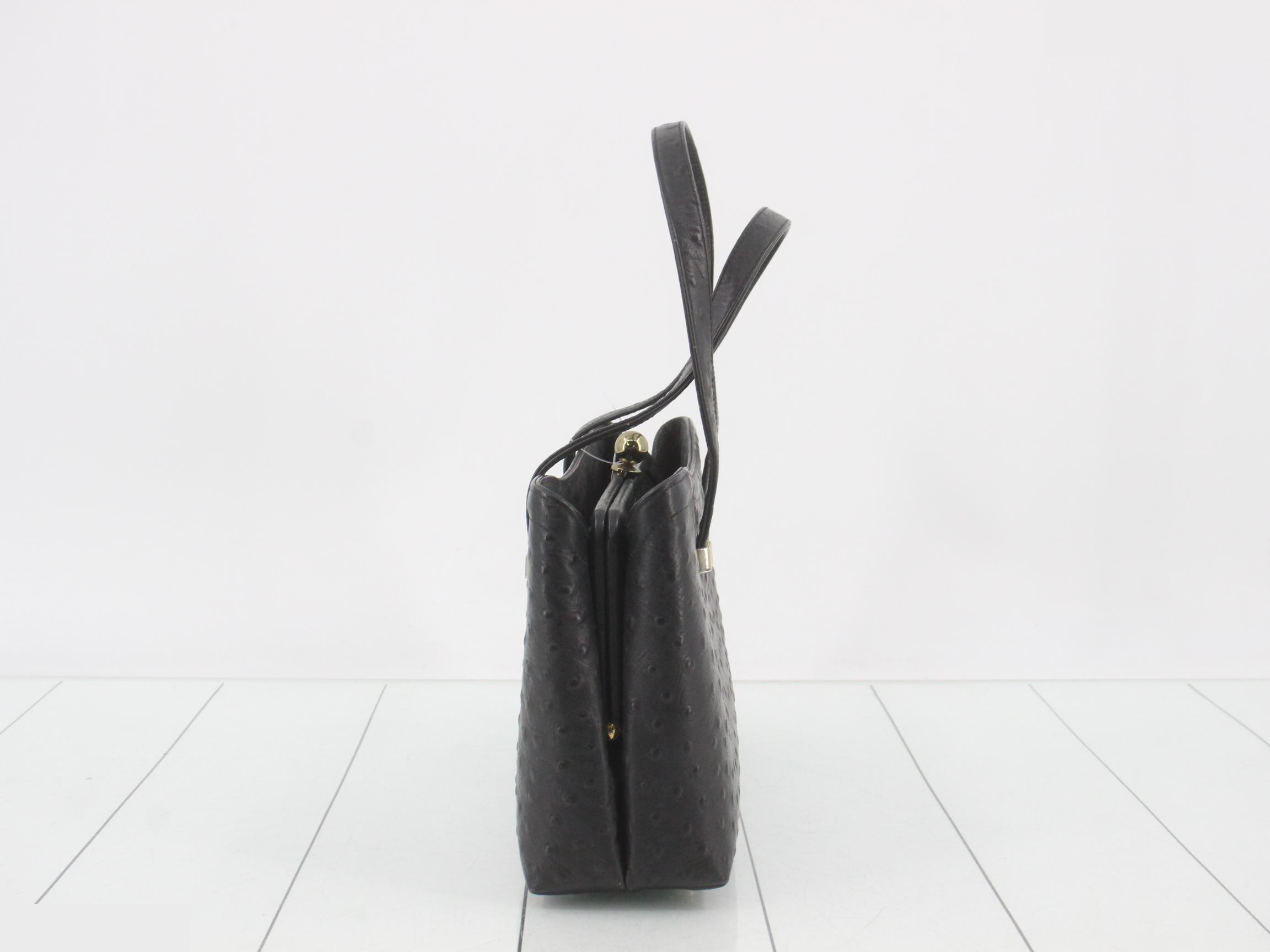 Black ostrich leather handbag with clasp closure. — view 4