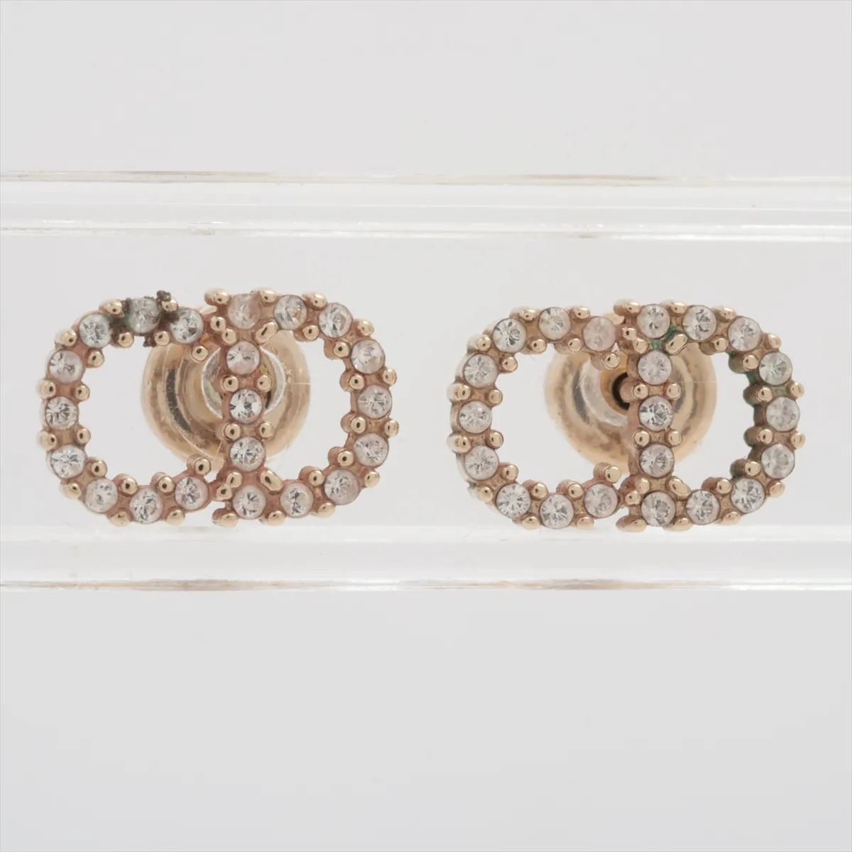 CD logo earrings (for both ears), gold-plated with rhinestones. Shows wear, tarnishing,