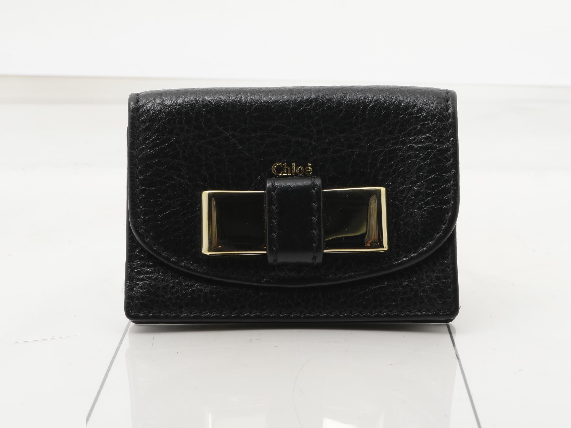 Leather card case with gold hardware.