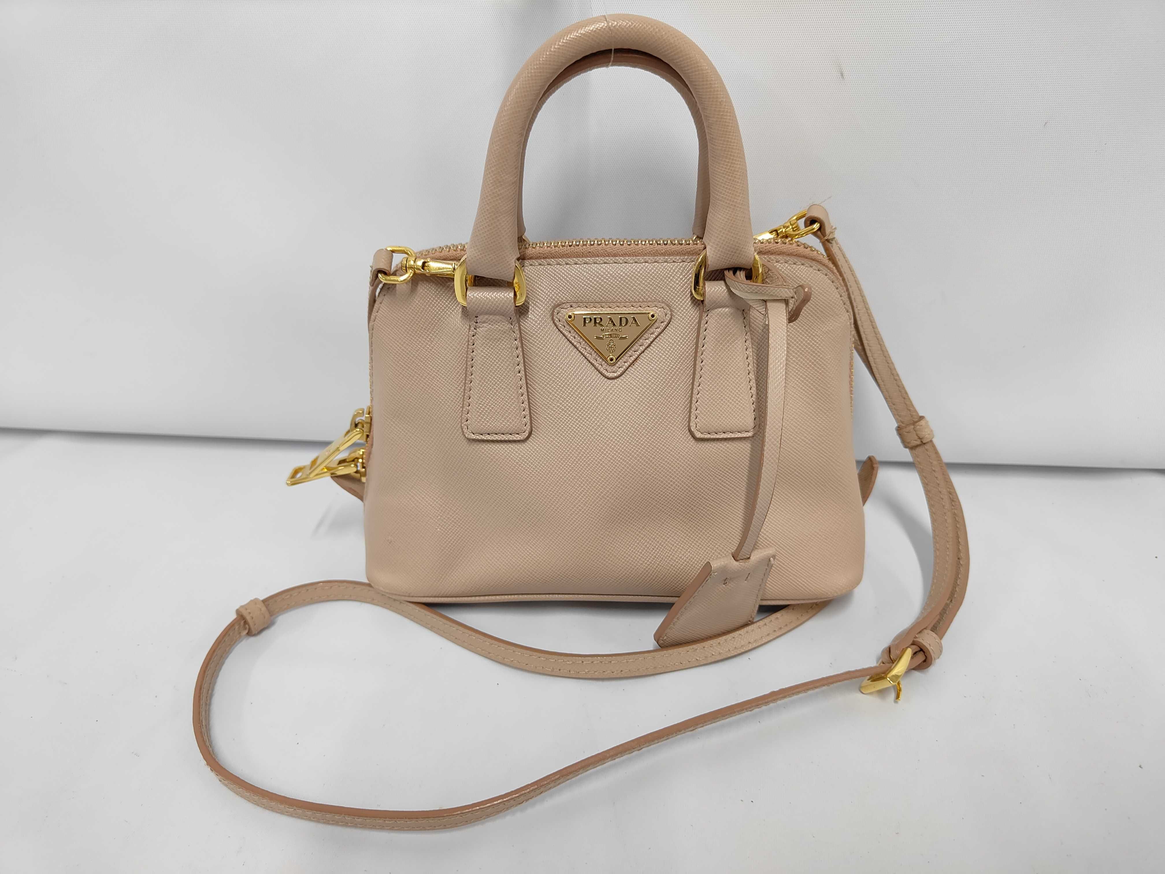 Saffiano Triangle Logo Promenade Leather 2-Way Mini Handbag