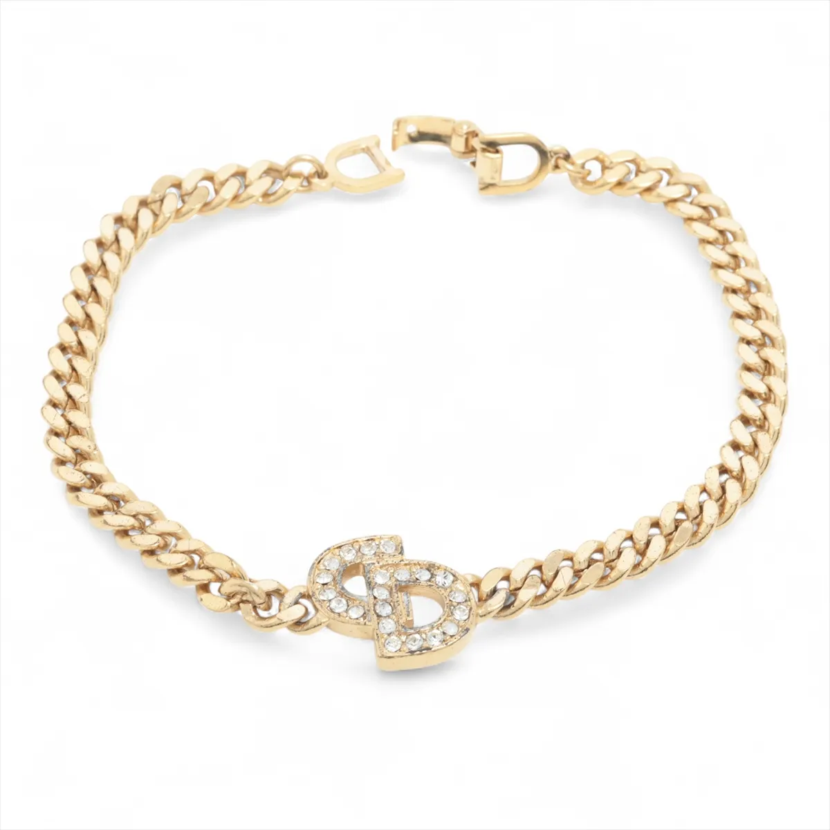 CD logo bracelet, gold plated with rhinestones. Shows signs of wear,