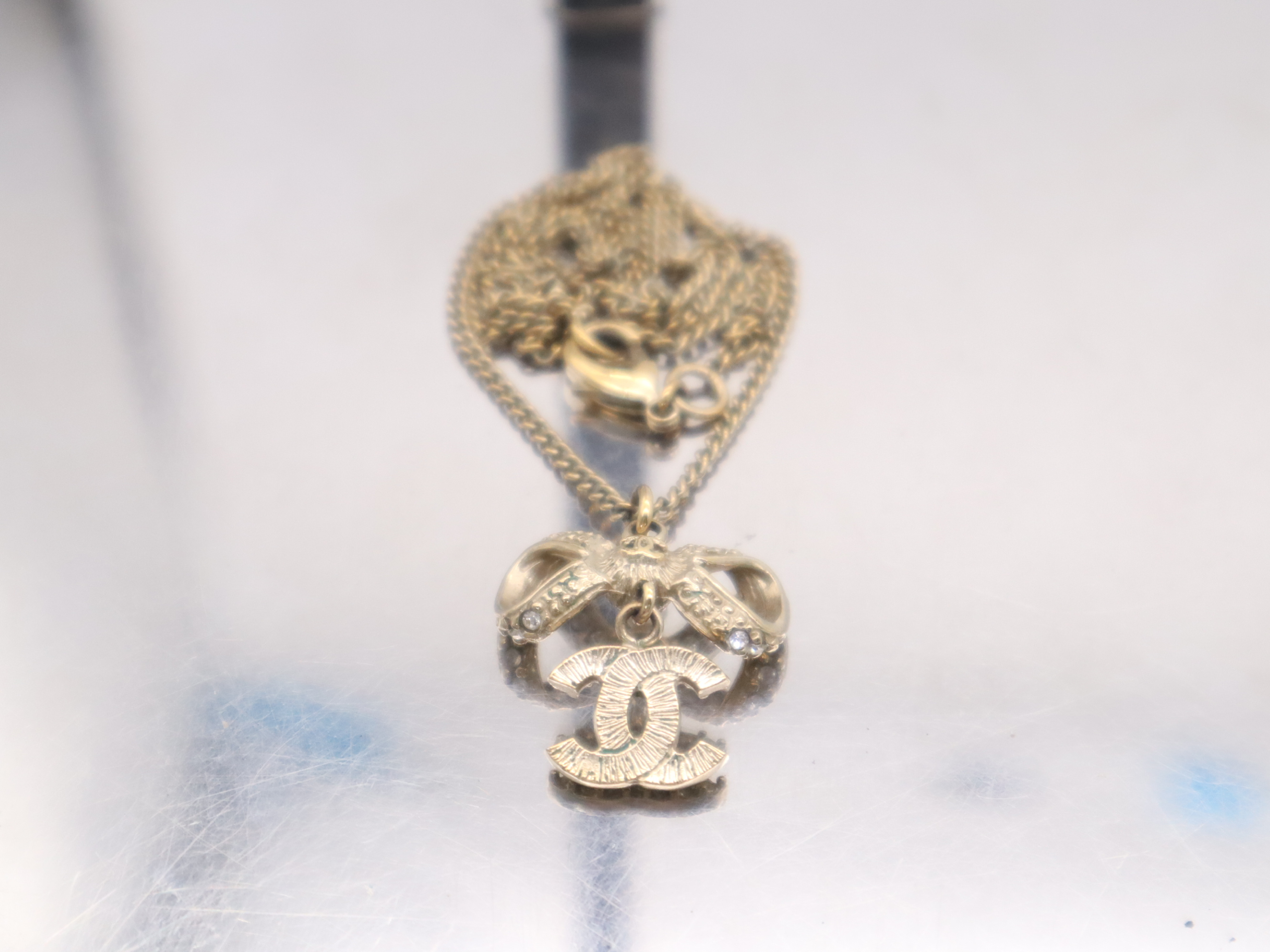 Gold Ribbon Coco Mark Necklace