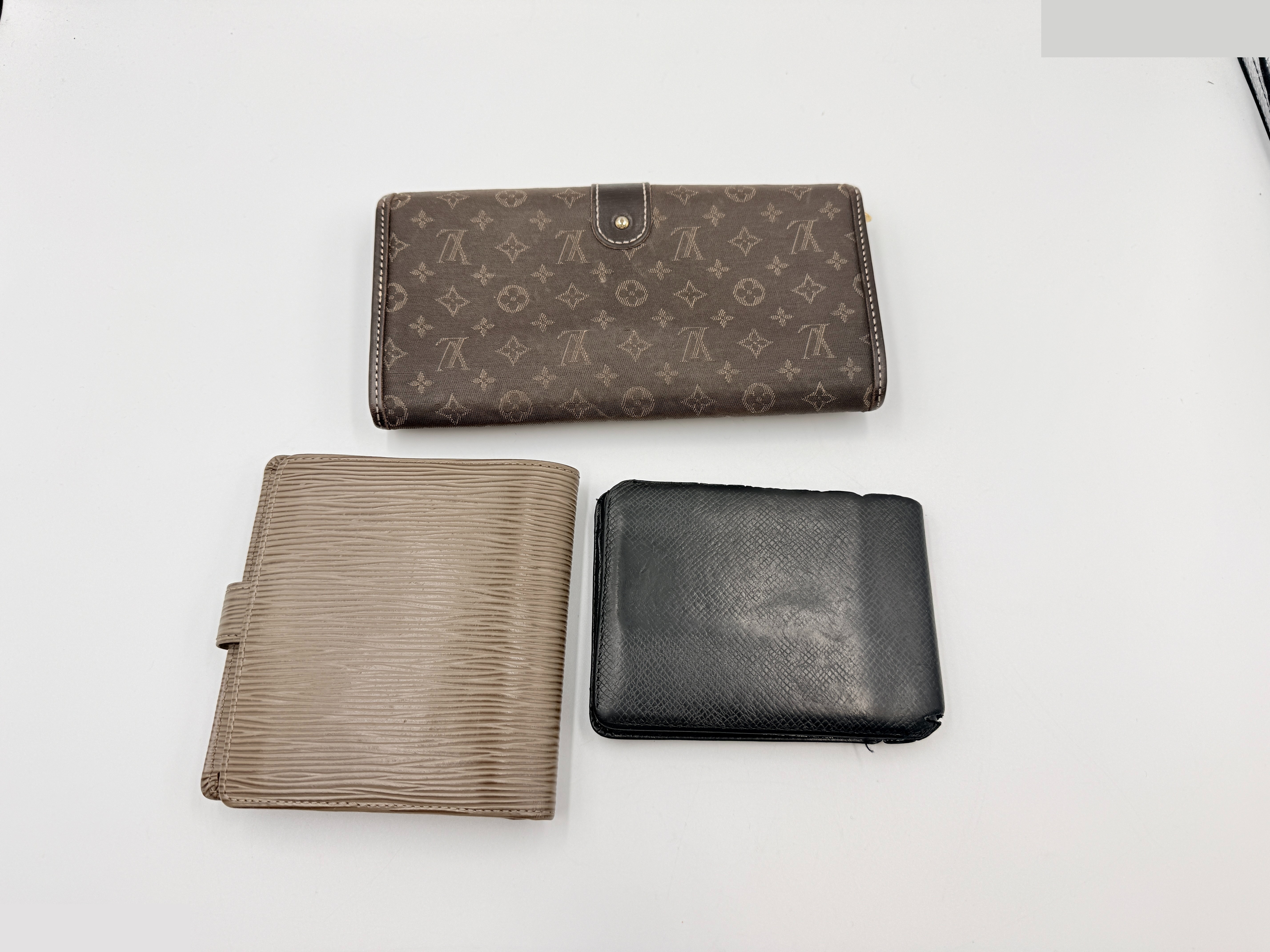 Three wallets: Monogram Mini Run long wallet, Epi folding wallet, and Daiga billfold. — view 2