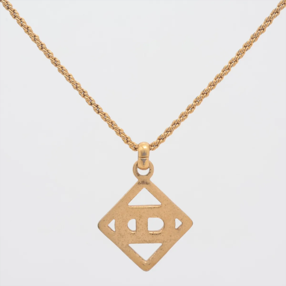 CD logo necklace, gold plated with rhinestones. Shows signs of wear, — view 2