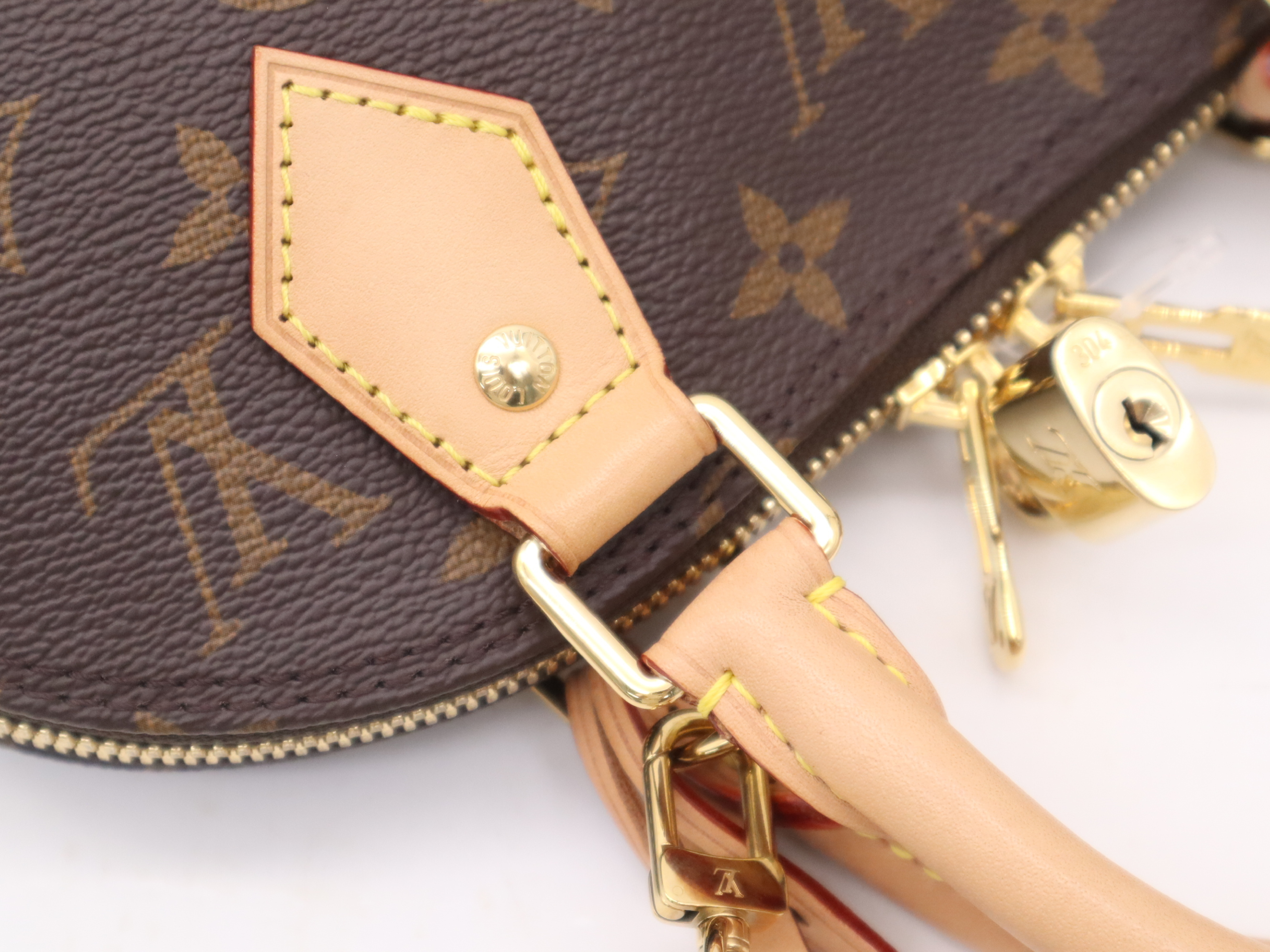M53152 Monogram Alma BB Handbag with Shoulder Strap, Padlock, 2 Keys, Clochette, and Dust Bag — view 7