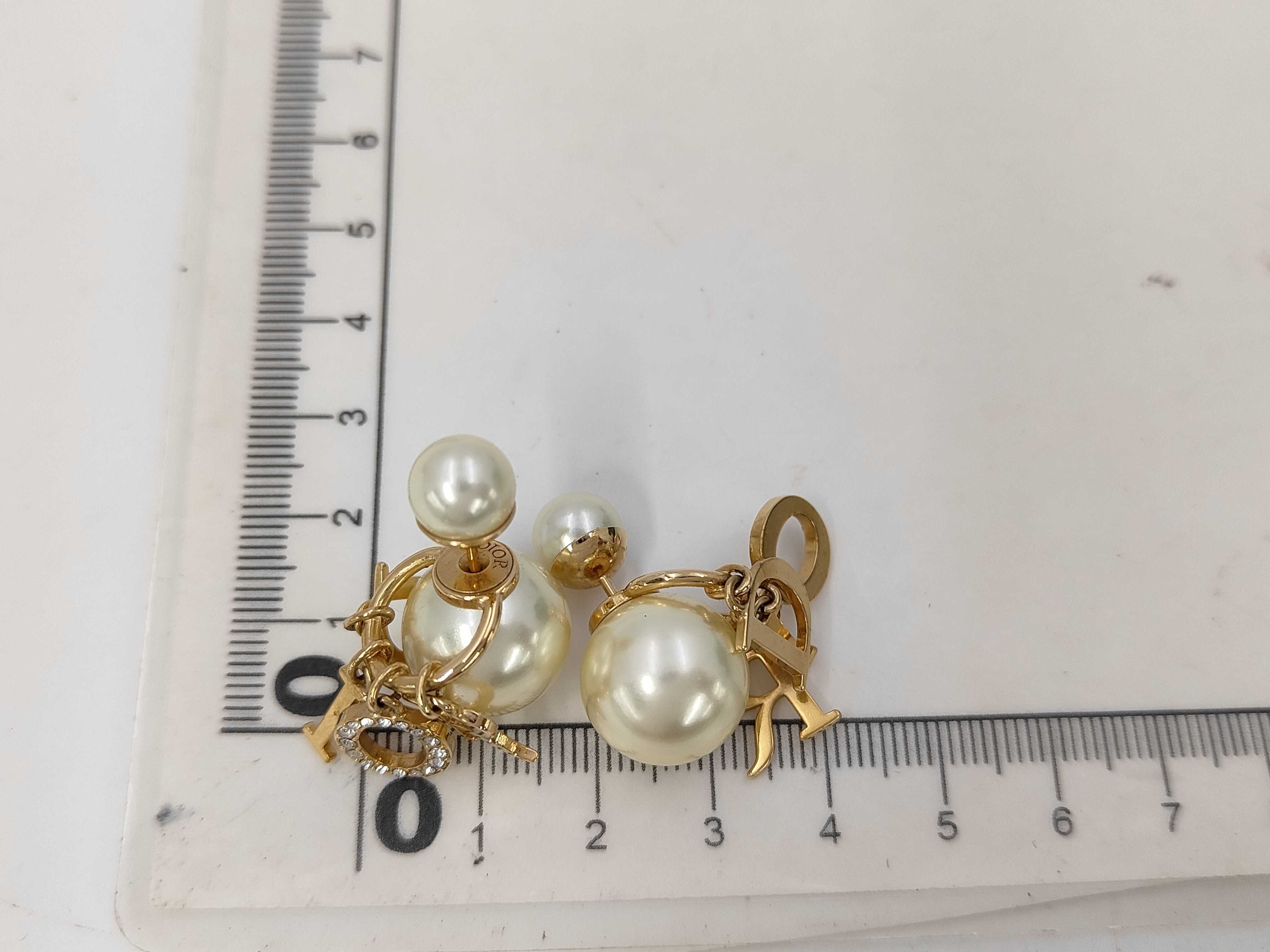 pearl logo earrings in box — view 7