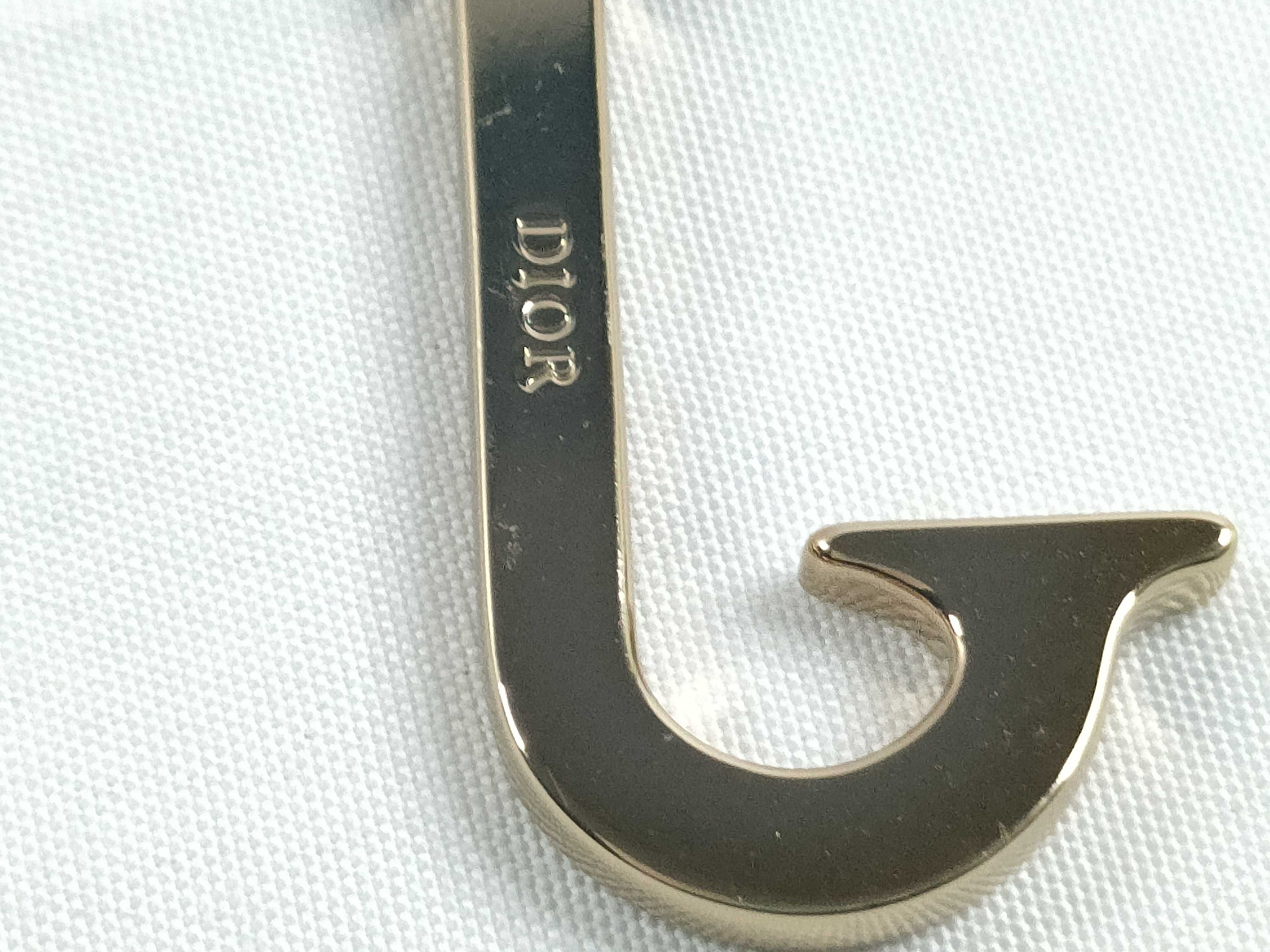 Roman alphabet charm, "J," with tag. — view 3