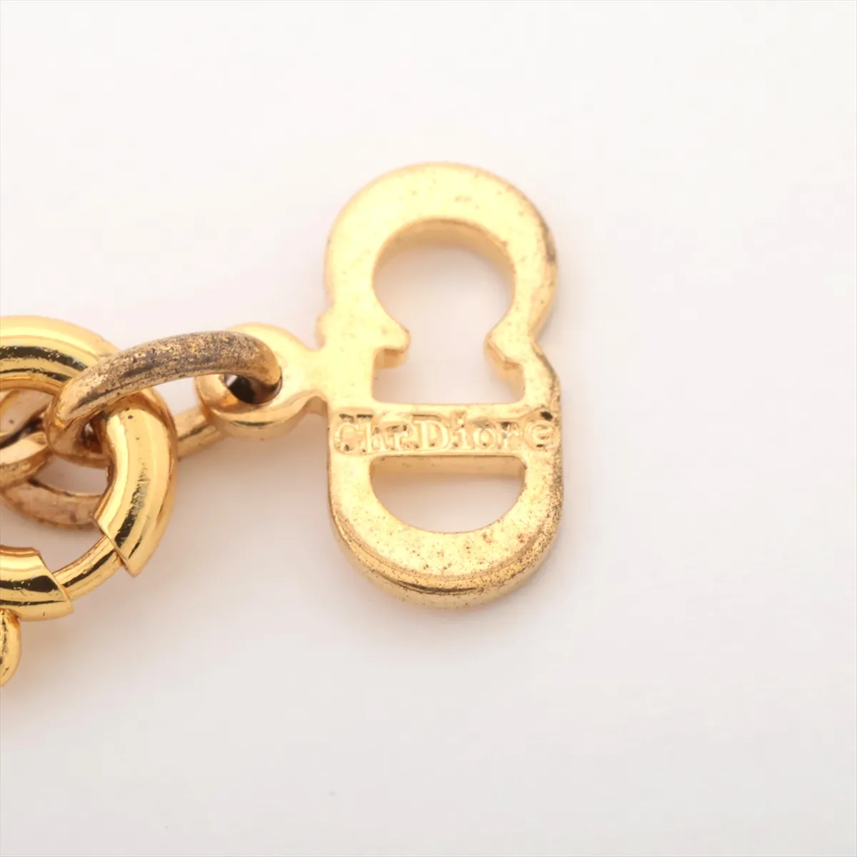 CD logo necklace, gold plated with rhinestones. Shows signs of wear, tarnishing, — view 4