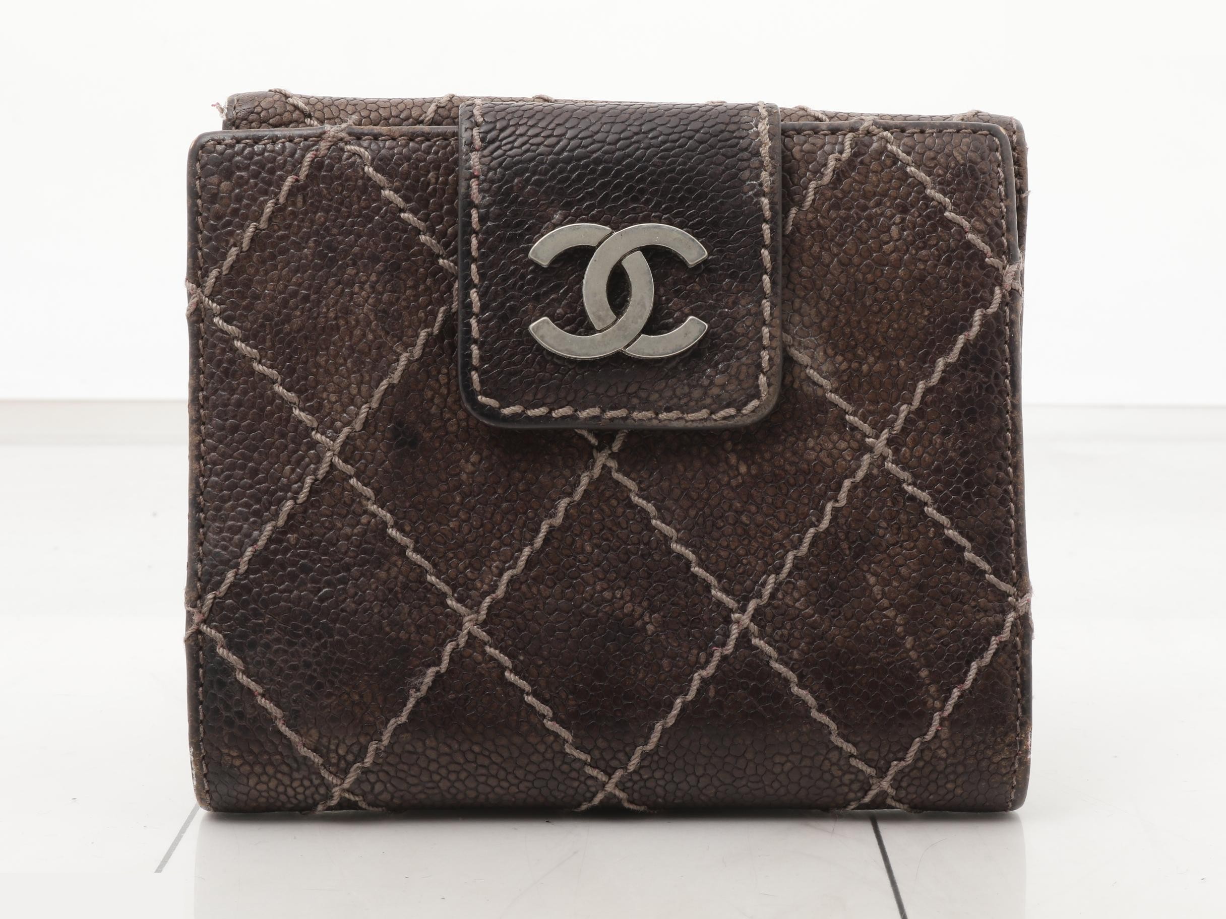 Tri-fold wallet, with sticker, serial number in the teens.