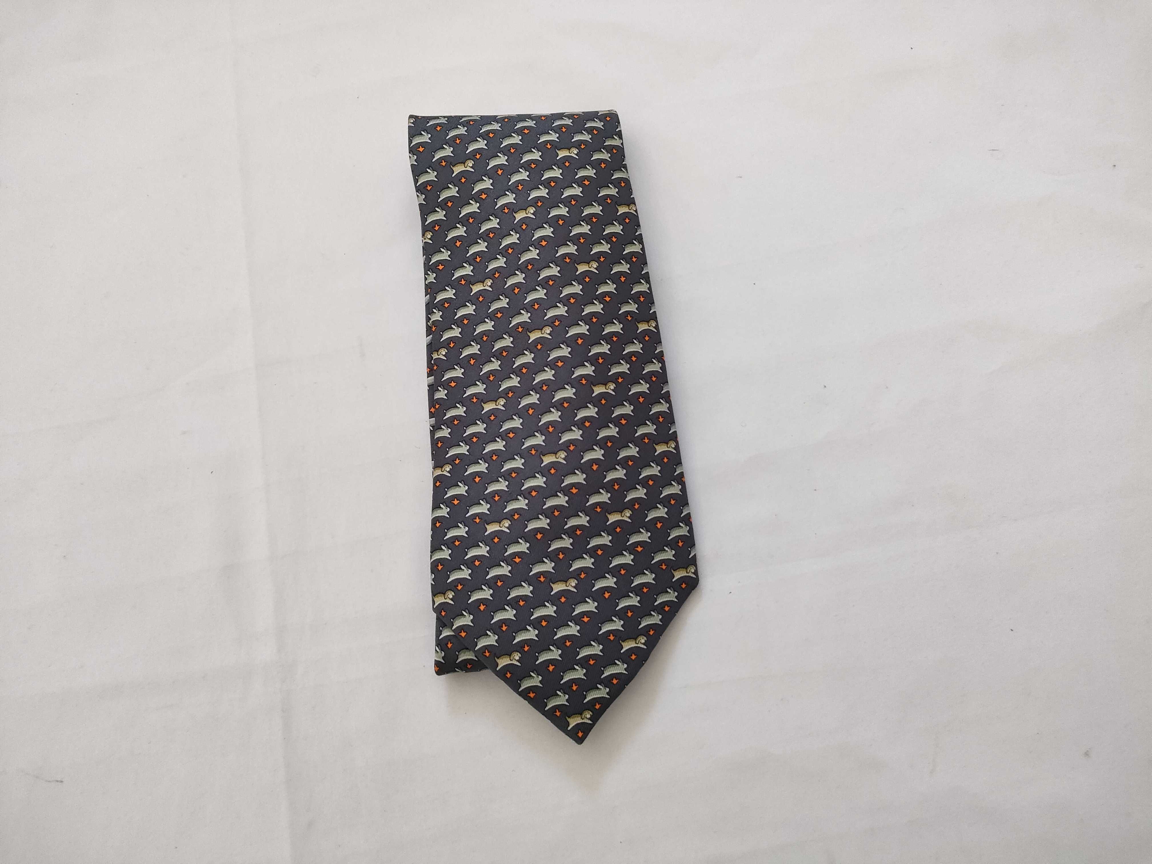 silk tie with animal print, navy blue, and other accessories.