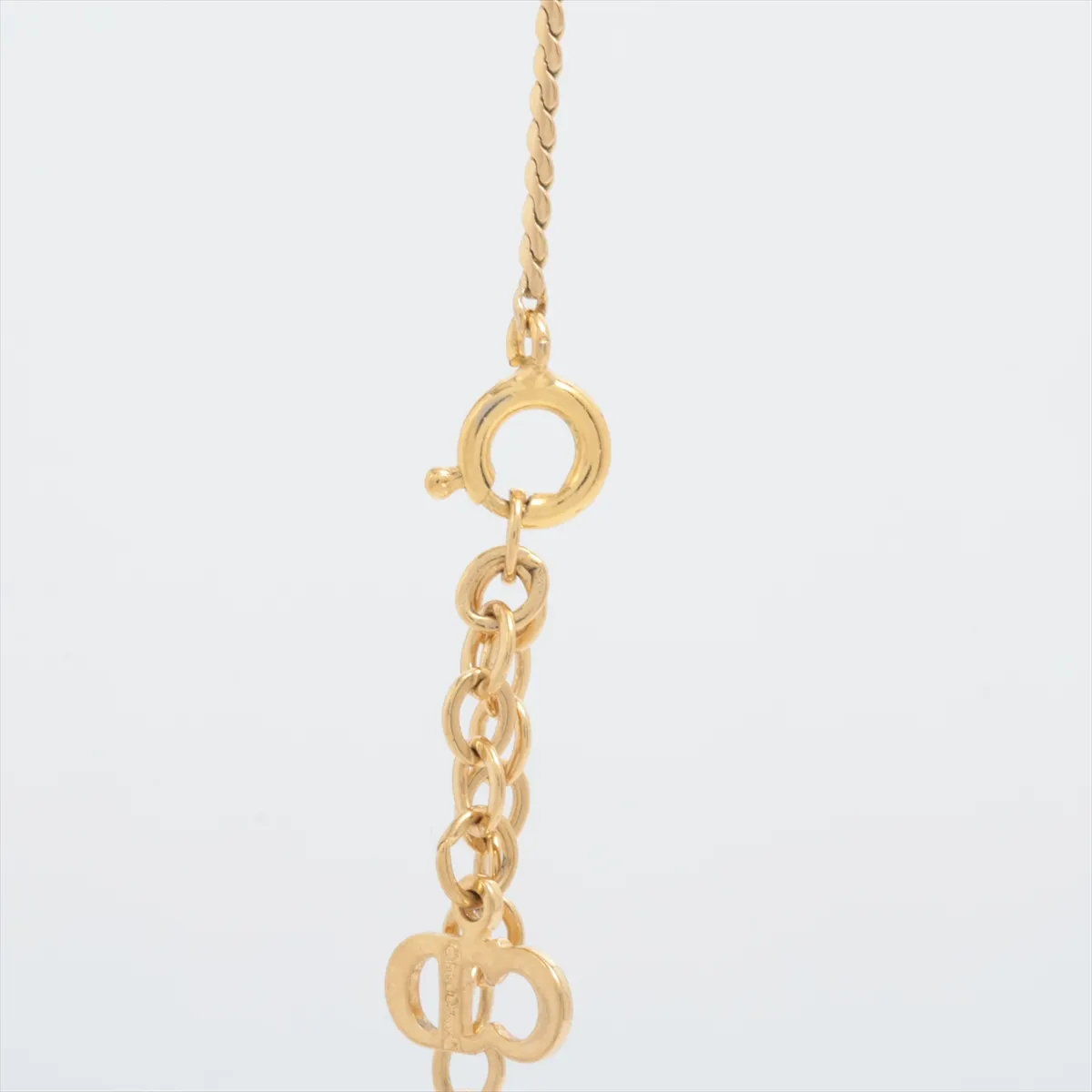 CD logo necklace, gold plated with rhinestones. Shows wear, tarnishing, — view 3