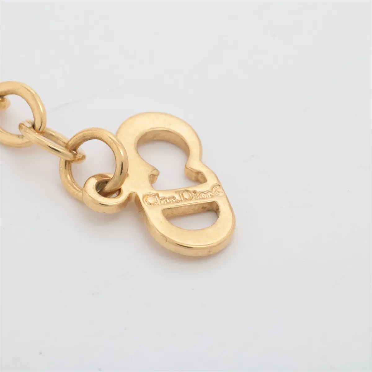 CD logo necklace, gold plated with rhinestones. Shows wear, tarnishing, — view 4