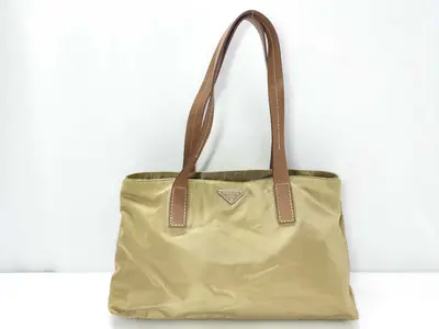 nylon tote bag in beige with triangular logo.