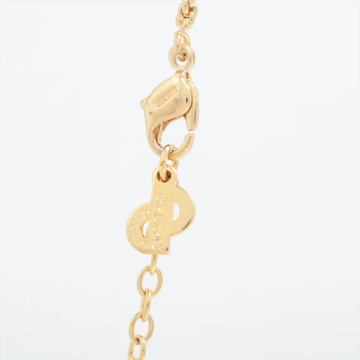 CD logo necklace, gold plated with rhinestones. Shows signs of wear, including — view 3