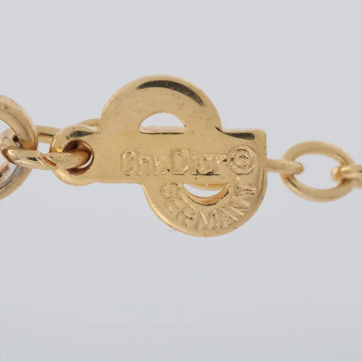 CD logo necklace, gold plated with rhinestones. Shows signs of wear, including — view 4