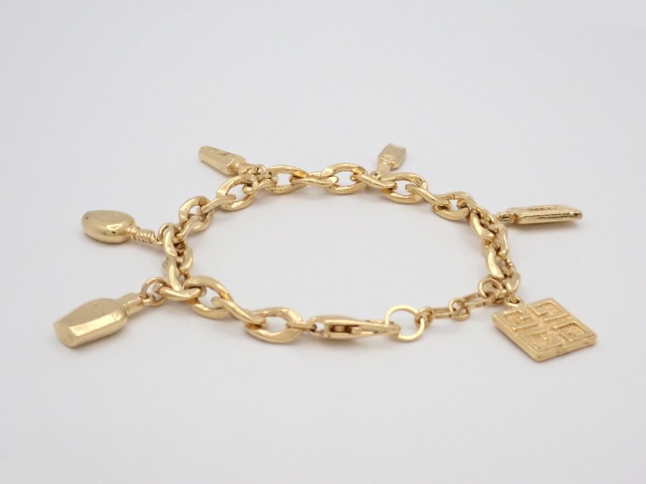 bracelet with multiple charms, gold, wrist circumference approximately 20.5 cm. — view 2