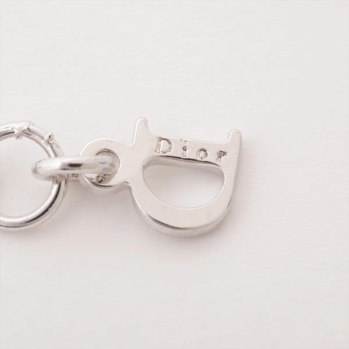 logo necklace, metal and rhinestones, silver. Shows wear, tarnishing, and discoloration. — view 4