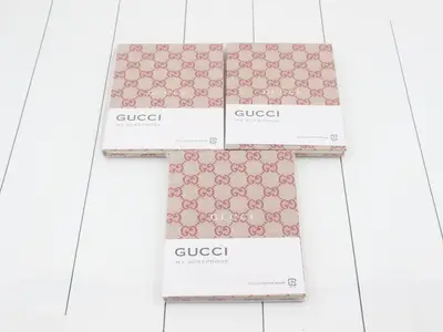 Unused Gucci novelty notebooks, set of 3.