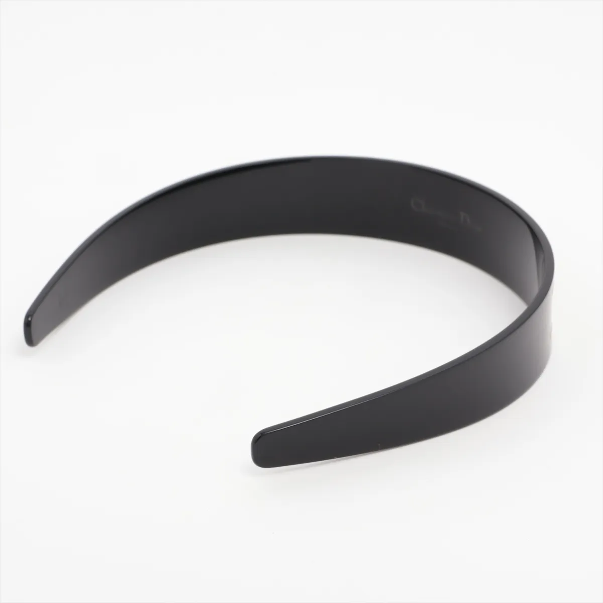 logo headband, plastic, black and gold. Shows signs of wear, — view 2