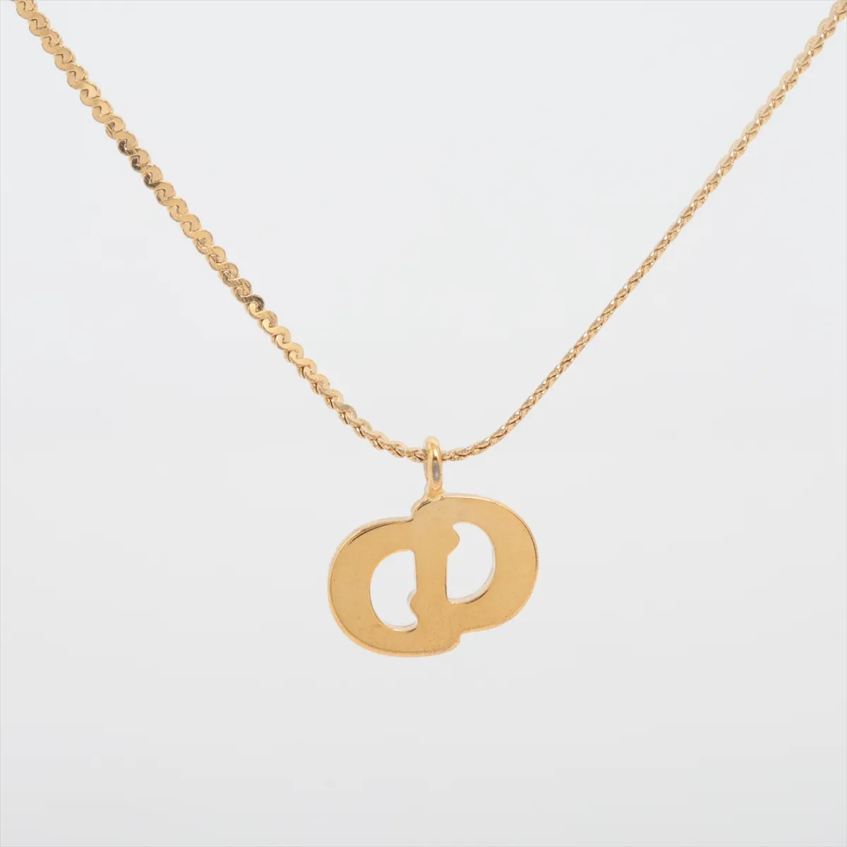 CD logo necklace, gold plated with rhinestones. Shows signs of wear, tarnishing, — view 2