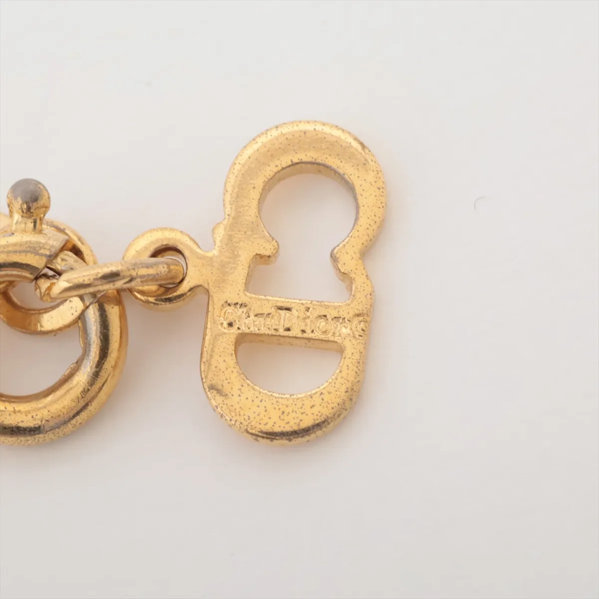 CD logo necklace, gold plated with rhinestones. Shows signs of wear, tarnishing, — view 4