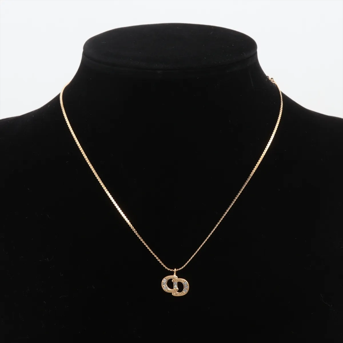 CD logo necklace, gold plated with rhinestones. Shows signs of wear, tarnishing, — view 5