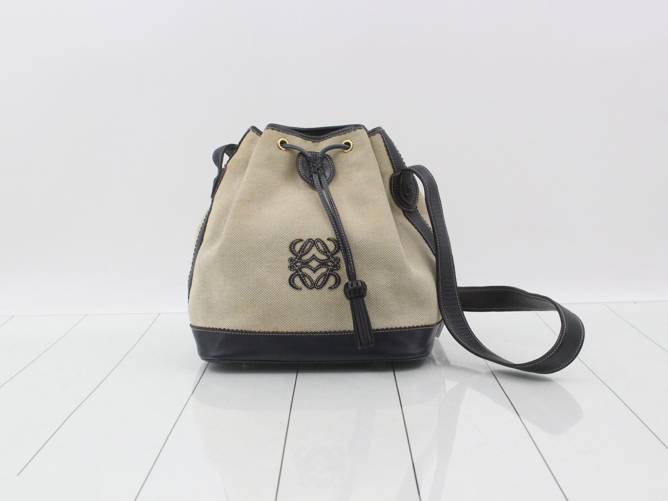 Canvas shoulder bag with drawstring closure, available in white and navy.