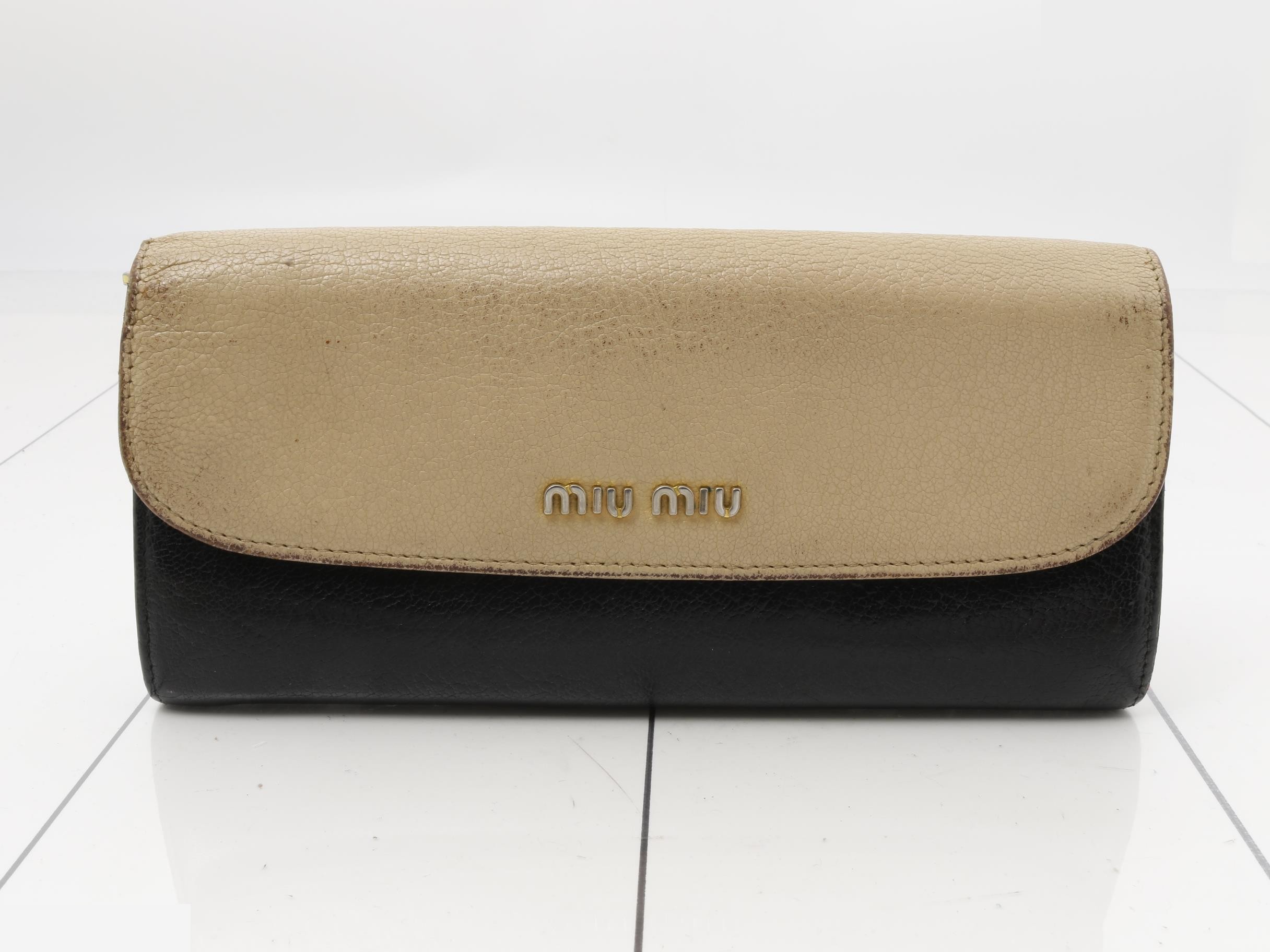 Bi-fold long wallet with coin purse, available in black/beige.